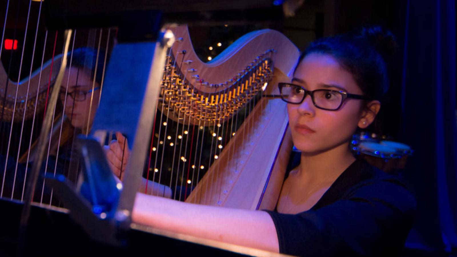 A girl plays the harp